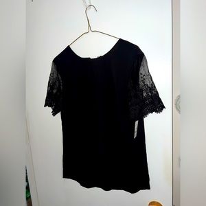 Black top with lace short sleeves. Single button closer at the back.